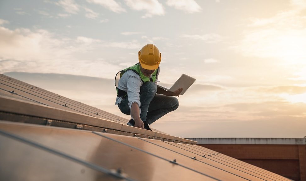 Service engineer checking solar cell on the roof for maintenance if there is a damaged part. Engineer worker install solar panel. Clean energy concept.